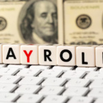 Keyboard with stacked cubes spelling out 'payroll'